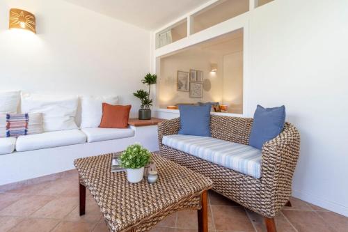 a living room with a couch and a table at Smeralda 15 in Porto Rotondo