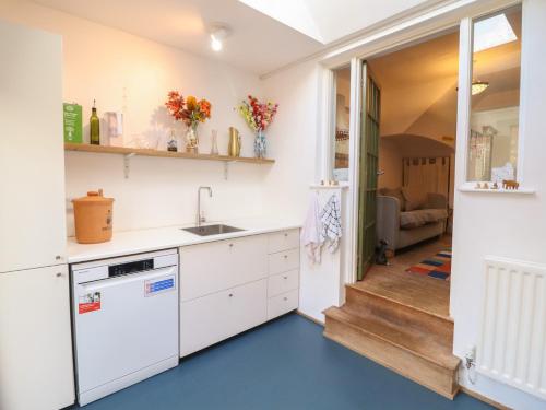 a kitchen with white cabinets and a blue floor at 32 Crescent Street in Newtown