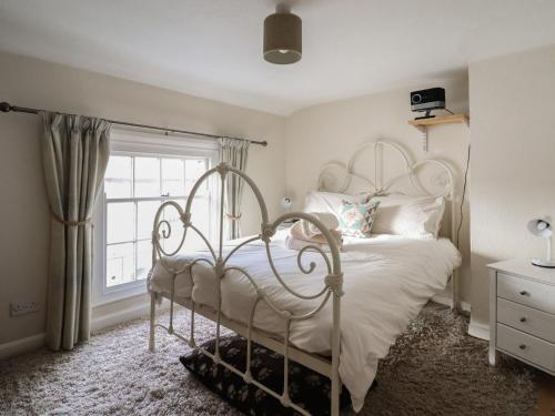 a bedroom with a white bed and a window at 32 Crescent Street in Newtown