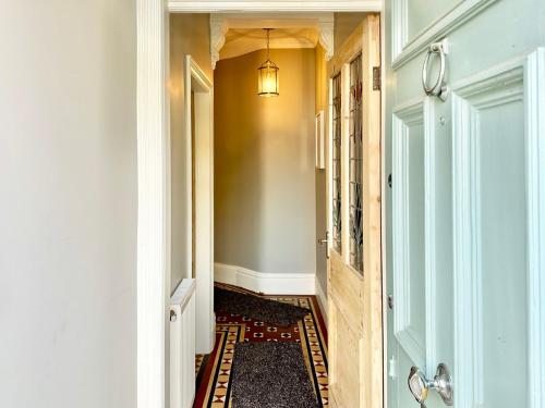a hallway with a chandelier on the wall and a hallway with a hallway at Montrose House in York