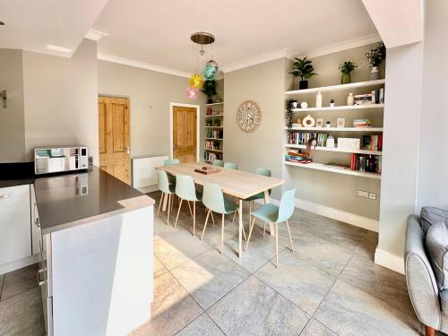 a kitchen and dining room with a table and chairs at Montrose House in York