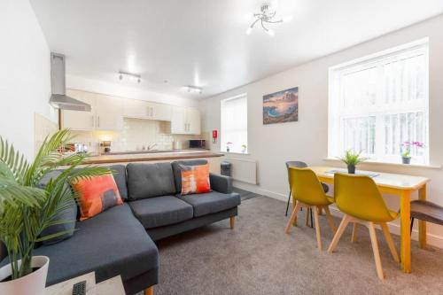 a living room with a couch and a table at NEW! Stylish 5-Bed Apartment in Stockton-on-tees by Stay With Us, Perfect for Contractors & Large Groups, FREE Parking! in Thornaby on Tees