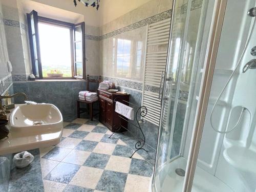 a bathroom with a sink and a shower at Torre Della Chiocciola in Monteriggioni