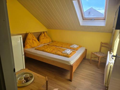 a bedroom with a bed in a room with a window at Király Szálló in Nagykanizsa