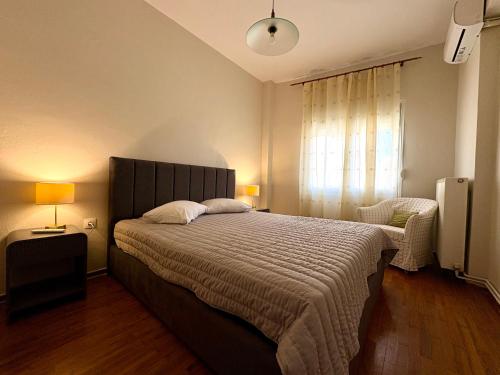 a bedroom with a large bed and a window at Radio House in Myrina