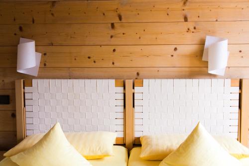 a living room with a couch and wooden walls at Bio-Landpension Monika in Leutasch