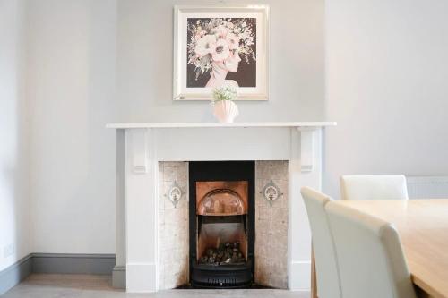 a fireplace with a picture on top of it at Family-Friendly 2BR Close to Durham City in Ushaw Moor