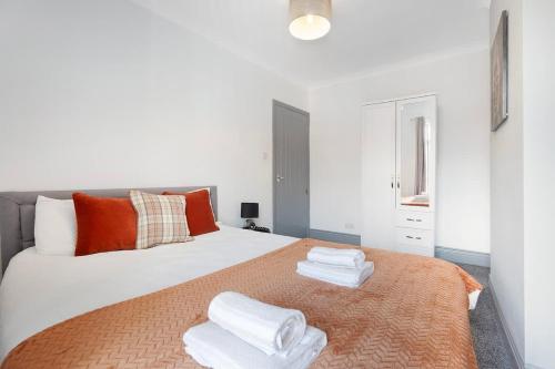 a bedroom with a large white bed with towels on it at Family-Friendly 2BR Close to Durham City in Ushaw Moor