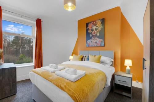 a bedroom with a large bed and a window at NEW! 4BR in Stanley in Annfield Plain