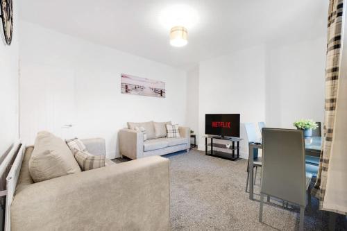 a living room with a couch and a tv at NEW! 4BR in Stanley in Annfield Plain