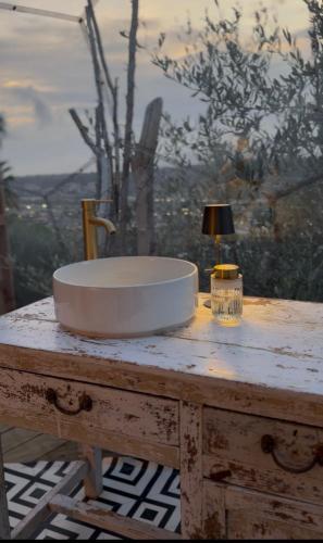 a sink on a table with a lamp on it at Dôme Nissaya in Nice