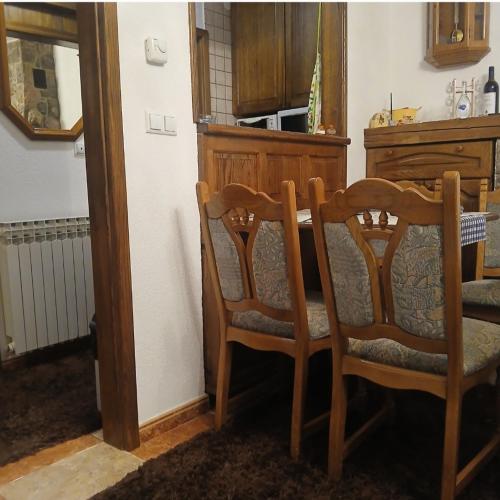 a dining room with a table and two chairs at Jahorina Ski View Apartman in Jahorina