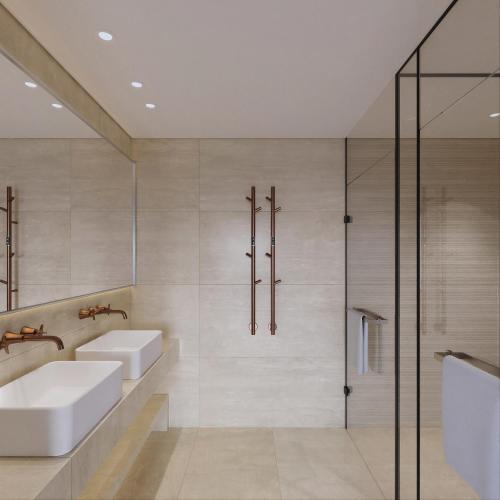 a bathroom with two sinks and a shower at Hotel Delfinia in Mythimna