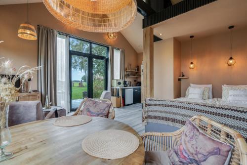 a bedroom with a bed and a table and chairs at De Witte Kip in Ruinen
