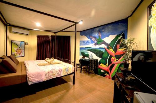 a bedroom with a canopy bed and a dining room at Alta Bohol Resort powered by Cocotel in Tagbilaran City