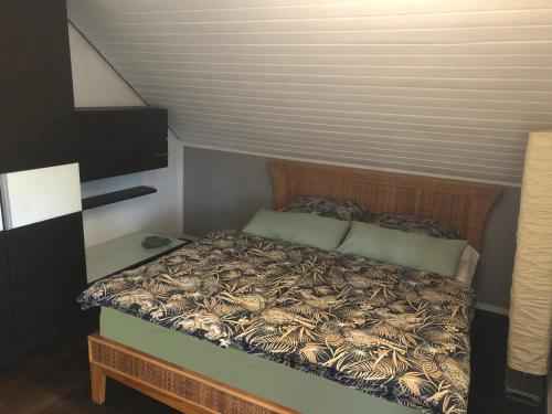a bedroom with a bed with a wooden head board at Ferienwohnung Untersee in Öhningen
