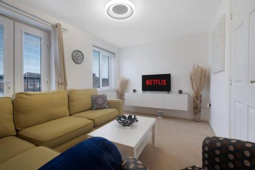 a living room with a couch and a table at New! Spacious Retreat for 10 Perfect for Families! in Bowburn
