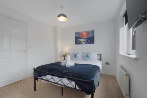 a bedroom with a bed in a white room at New! Spacious Retreat for 10 Perfect for Families! in Bowburn