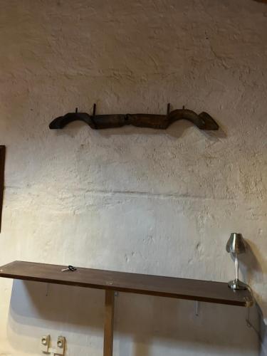 a wooden shelf on the wall of a room at Chez Bobby in Montréal