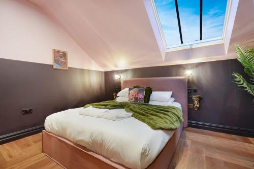 a bedroom with a large bed with white sheets and a window at Chic Retreat with King Bed in Barnard Castle in Barnard Castle