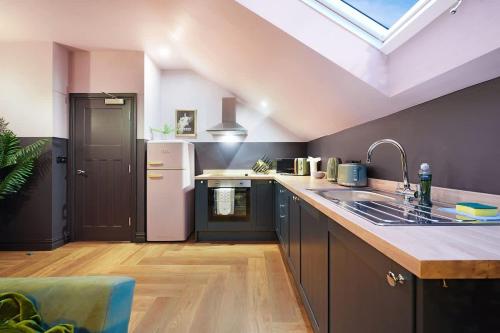 a kitchen with a skylight and a sink and a counter at Chic Retreat with King Bed in Barnard Castle in Barnard Castle