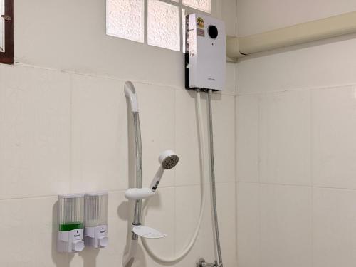a shower in a bathroom with a shower head at โอโซนริมน้ำเขาใหญ่ in Ban Pang Kae