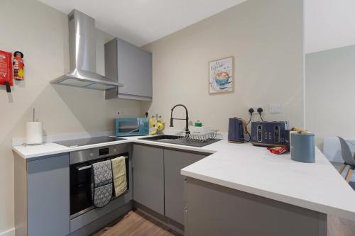 a kitchen with white counters and a stove top oven at Flat3 1BR in Horsemarket in Barnard Castle