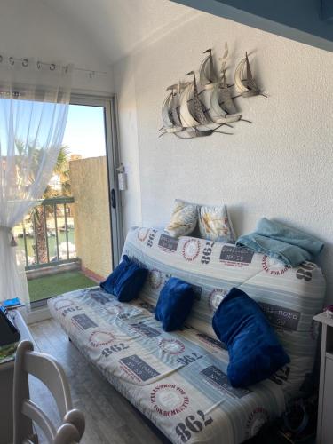 a bedroom with two beds with pillows on it at Pause Soleil in Gruissan