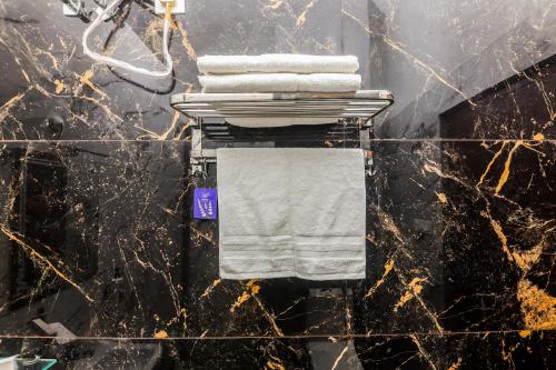 a pile of towels on a rack in a bathroom at Mukteshwar Valley Resort in Mukteshwar