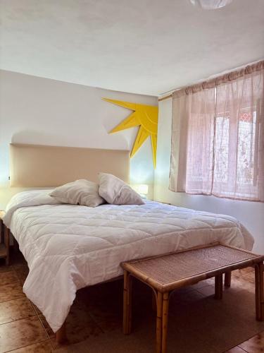 a bedroom with a large bed with a star on the wall at Cavo Beach 3 in Cavo