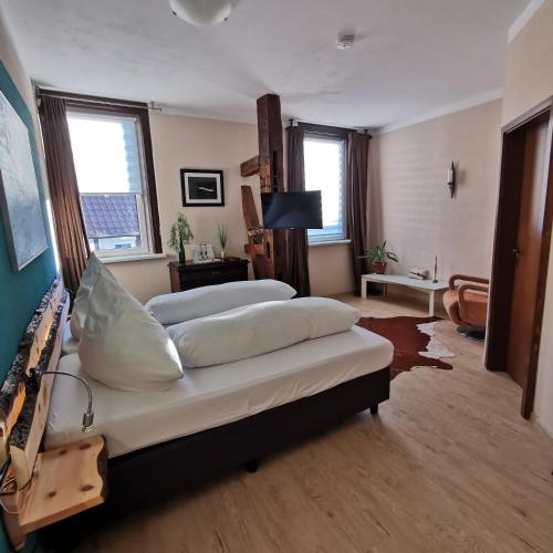 a bedroom with two beds and a living room at Ratskeller in Salzhemmendorf