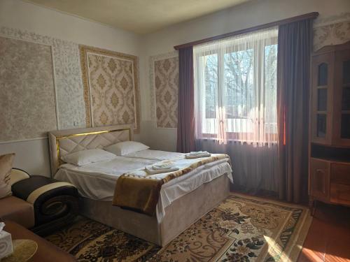 a bedroom with a bed and a large window at Sanahin Old&New in Alaverdi