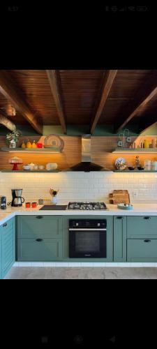 a kitchen with blue cabinets and a stove top oven at Igarata Cabana da Sol in Igaratá