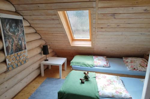 a room with two beds in a log cabin at Chatka pod lasem Szczyrk Domek z jacuzzi in Szczyrk