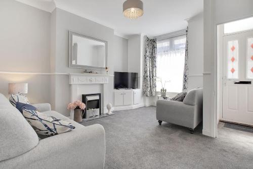 a living room with a couch and a fireplace at Stylish 3-Bedroom Oasis in Darlington, Sleeps 5 in Darlington