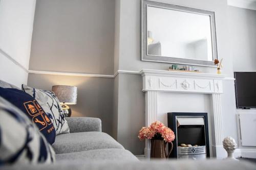 a living room with a fireplace and a mirror at Stylish 3-Bedroom Oasis in Darlington, Sleeps 5 in Darlington