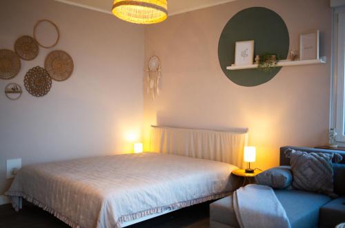 a bedroom with a bed and a couch at Ferienwohnung Saarglück in Merzig