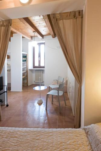 a bedroom with a bed and a table and a chair at Casa Cortese Sirolo in Sirolo