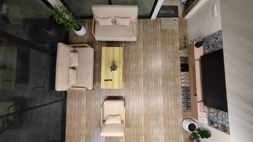 an overhead view of a room with a bed and chairs at บ้านฮา พอชเทล Baan Ha Poshtel in Nan