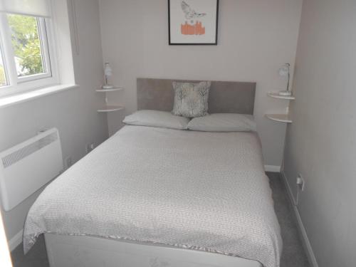 a small bedroom with a bed in a room at Acorns in Wavehorne