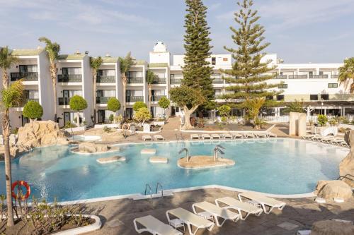 a large swimming pool in front of a hotel at BLUESEA Costa Bastian in Costa Teguise