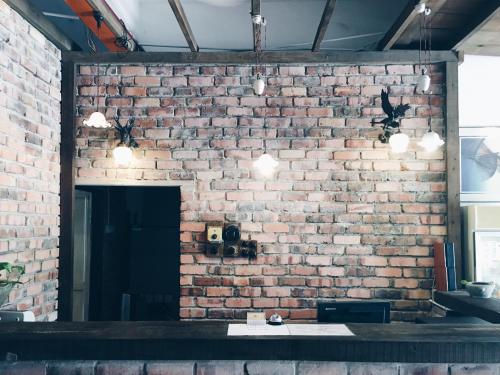 a brick wall with a counter in front of it at Rock Wood Hotel in Sungai Petani