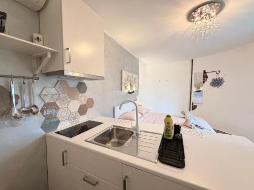 a small white kitchen with a sink and a sink at Silos Holiday in Dajla