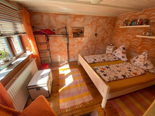 a room with a bed and a couch and a window at Ferienhaus Deubel Escobar in Kappeln