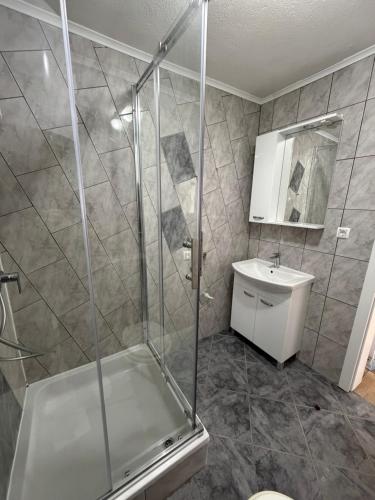 a bathroom with a shower and a toilet and a sink at SeaLaVir Apartments in Vir