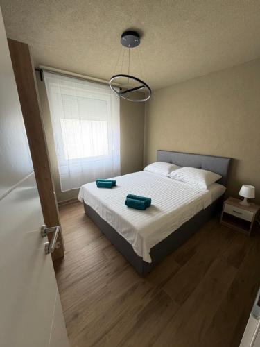 a bedroom with a bed with two pillows on it at SeaLaVir Apartments in Vir