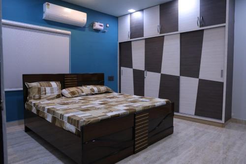 a bedroom with a large bed in a room at Premium House or Office In Amaravati in Sūriapālem