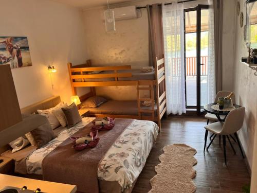 a bedroom with a bunk bed with two stuffed animals on it at Dionis in Veliko Gradište