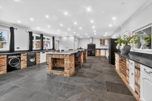 a kitchen with a brick fireplace in a house at The PADhouse in York
