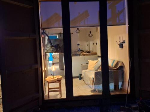 a bedroom with a bed and a table with a lamp at Eco Hideaway in Anoyira